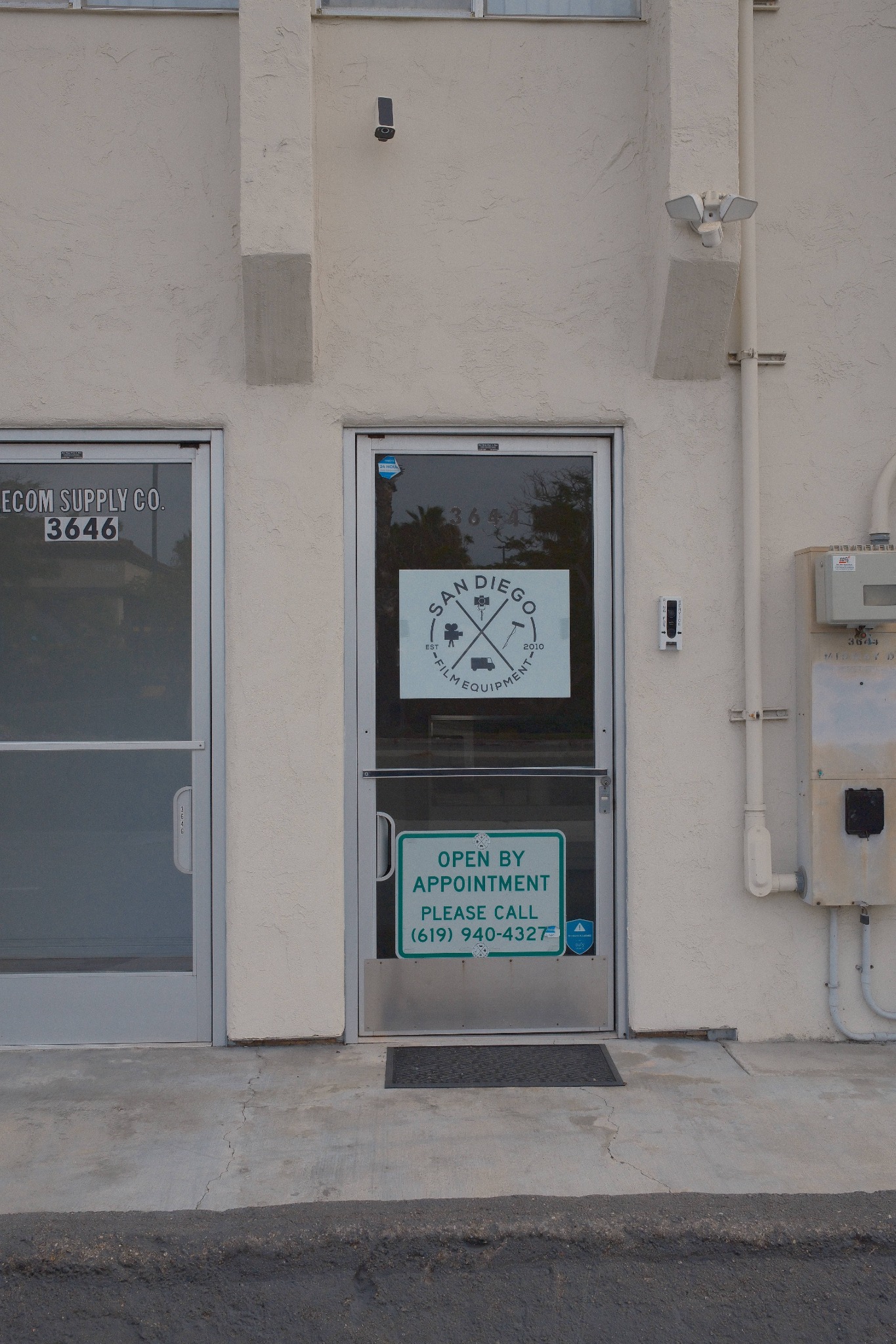 Entrance at 3644 Midway Drive with the San Diego Film Equipment logo on the glass door